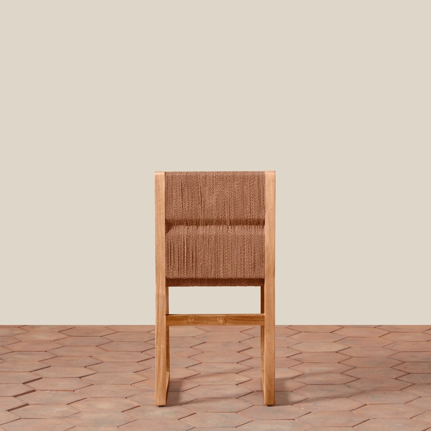 Wooden chair with woven backrest on a wooden floor and beige wall background- Number 6