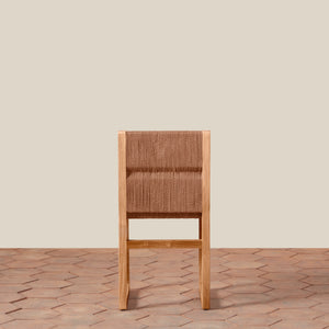 Wooden chair with woven backrest on a wooden floor and beige wall background - Number 6