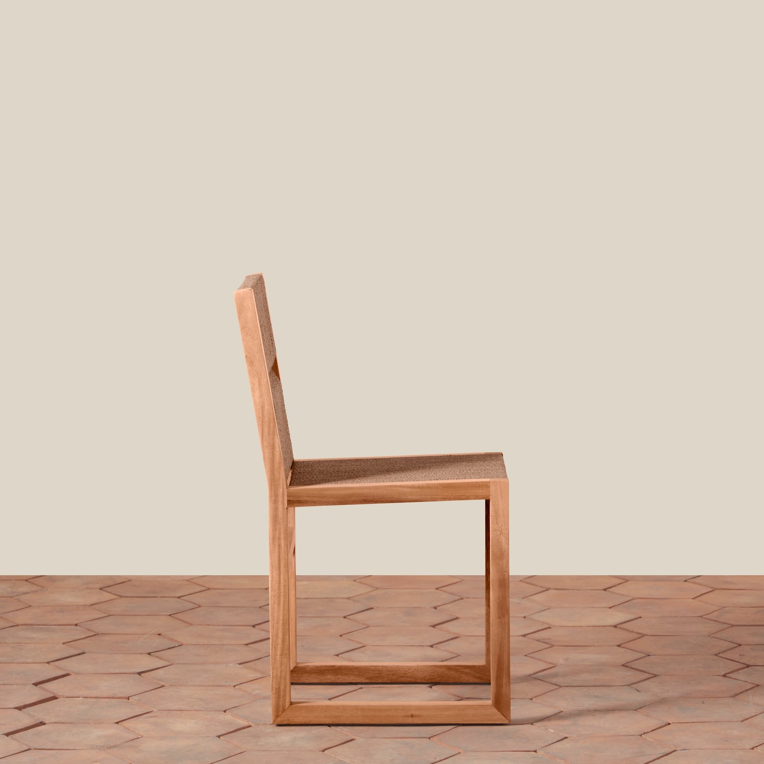 Wooden chair on a wooden floor with a beige wall background- Number 4