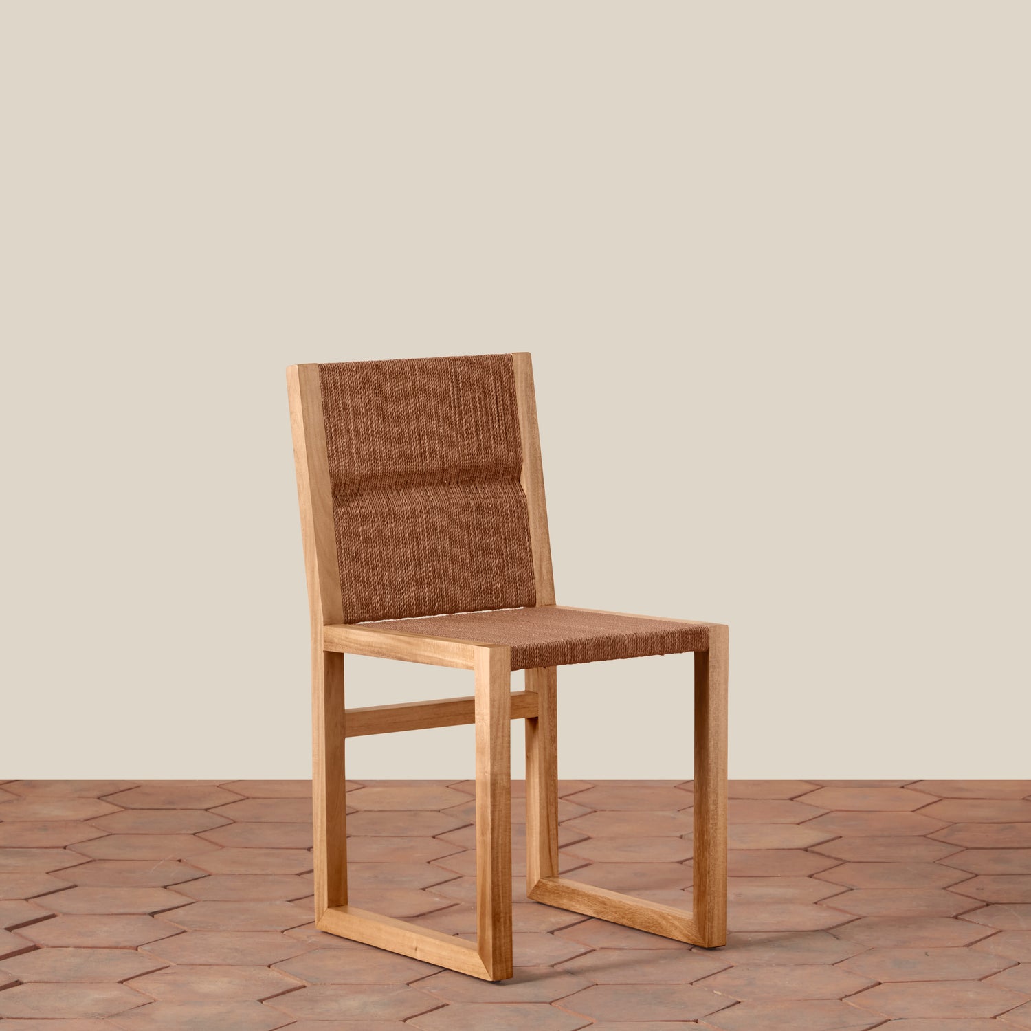 Wooden chair with woven backrest on a wooden floor and beige wall background- Number 1