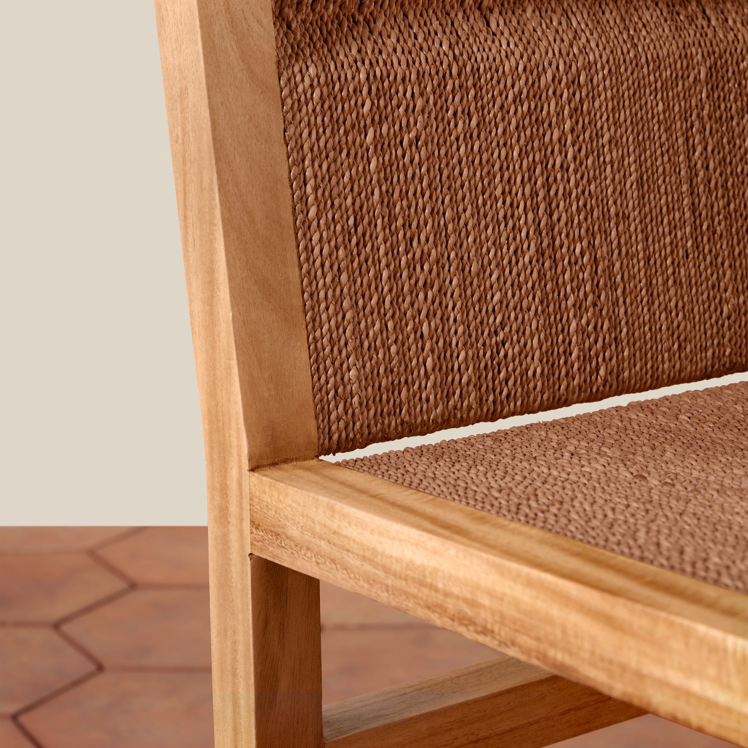 Close-up of a wooden chair with woven brown backrest and seat.- Number 7