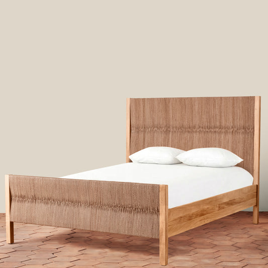 Wooden bed with white bedding on a beige background