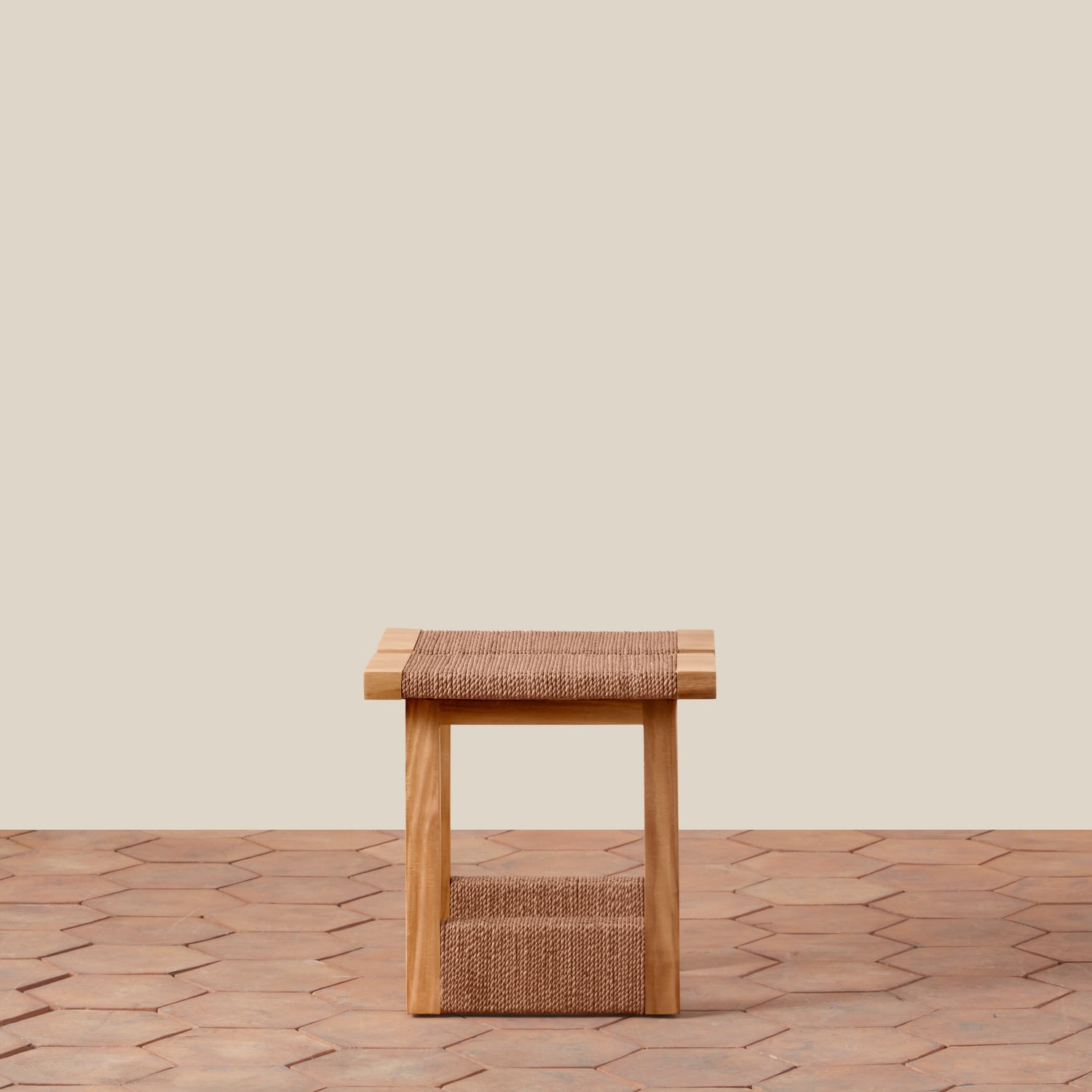 Wooden stool with woven seat on a wooden floor against a beige wall- Number 5
