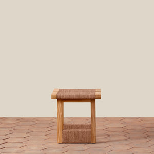 Wooden stool with woven seat on a wooden floor against a beige wall - Number 5