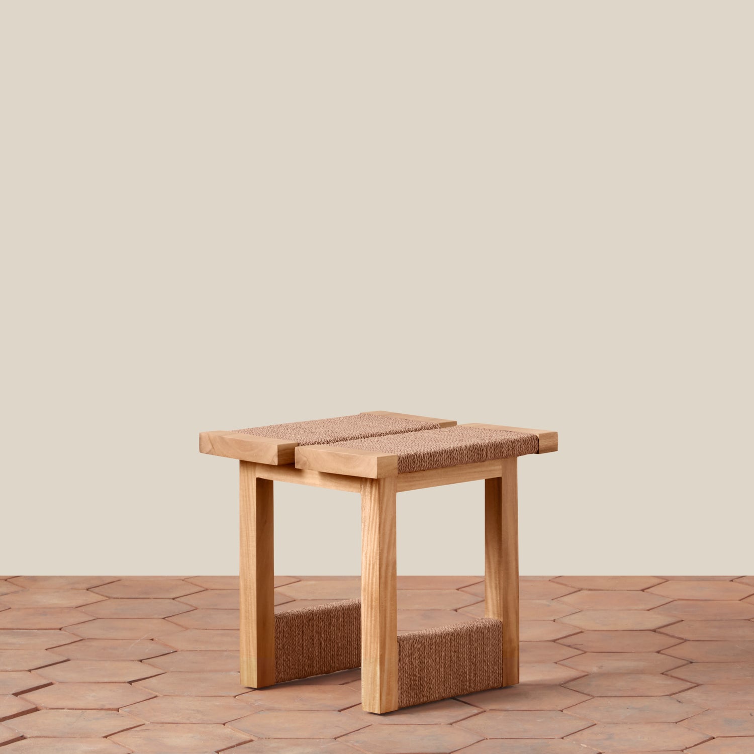 Wooden stool with woven seat and backrest on a wooden floor.- Number 1