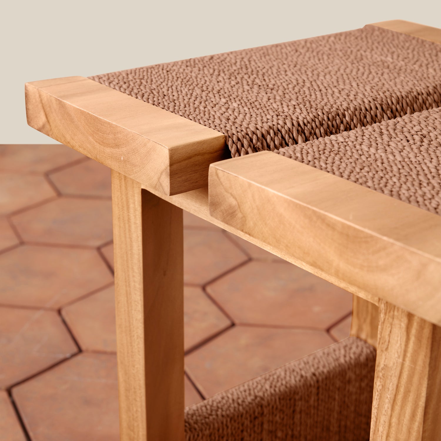 Wooden bench with textured brown cushioning on a stone pavement- Number 6