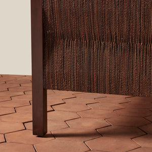 Close-up of a textured brown bedframe on tiled floor - Number 9