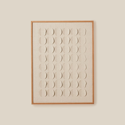 Framed artwork with geometric pattern on a beige wall