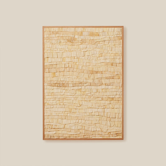 Textured wall art piece with a wooden frame on a beige wall
