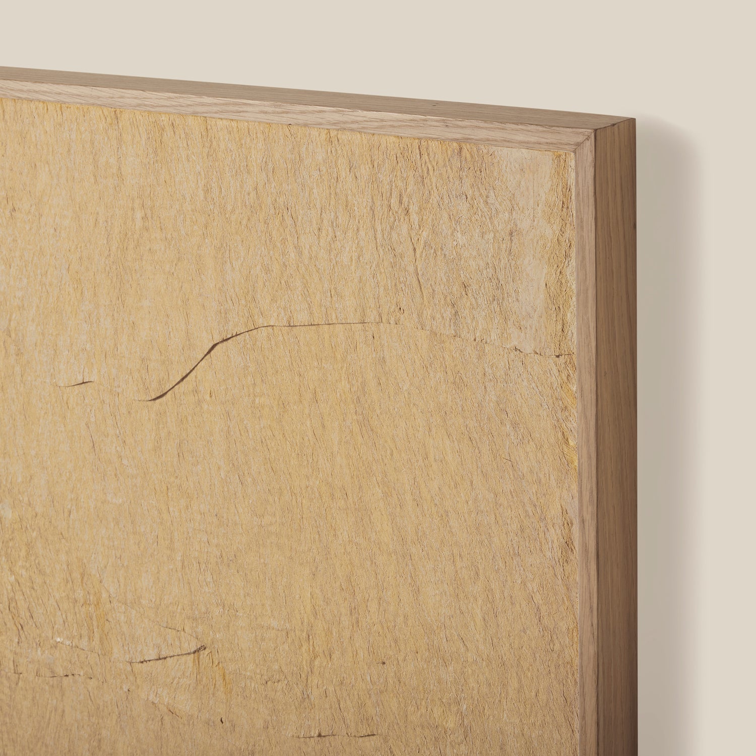 Wooden frame with a textured surface on a beige wall- Number 4