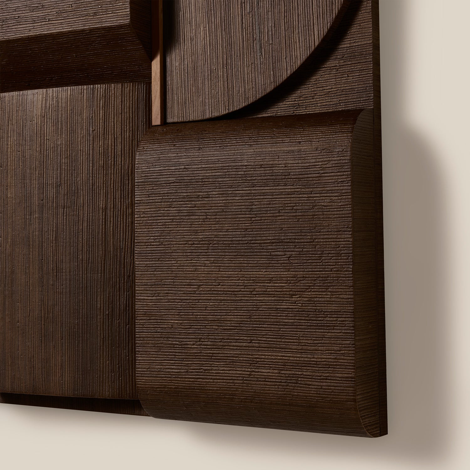 Close-up of a dark wood panel with geometric design on a beige background- Number 4