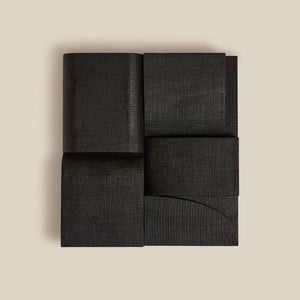 Black fabric wall art on a beige background - Number 1