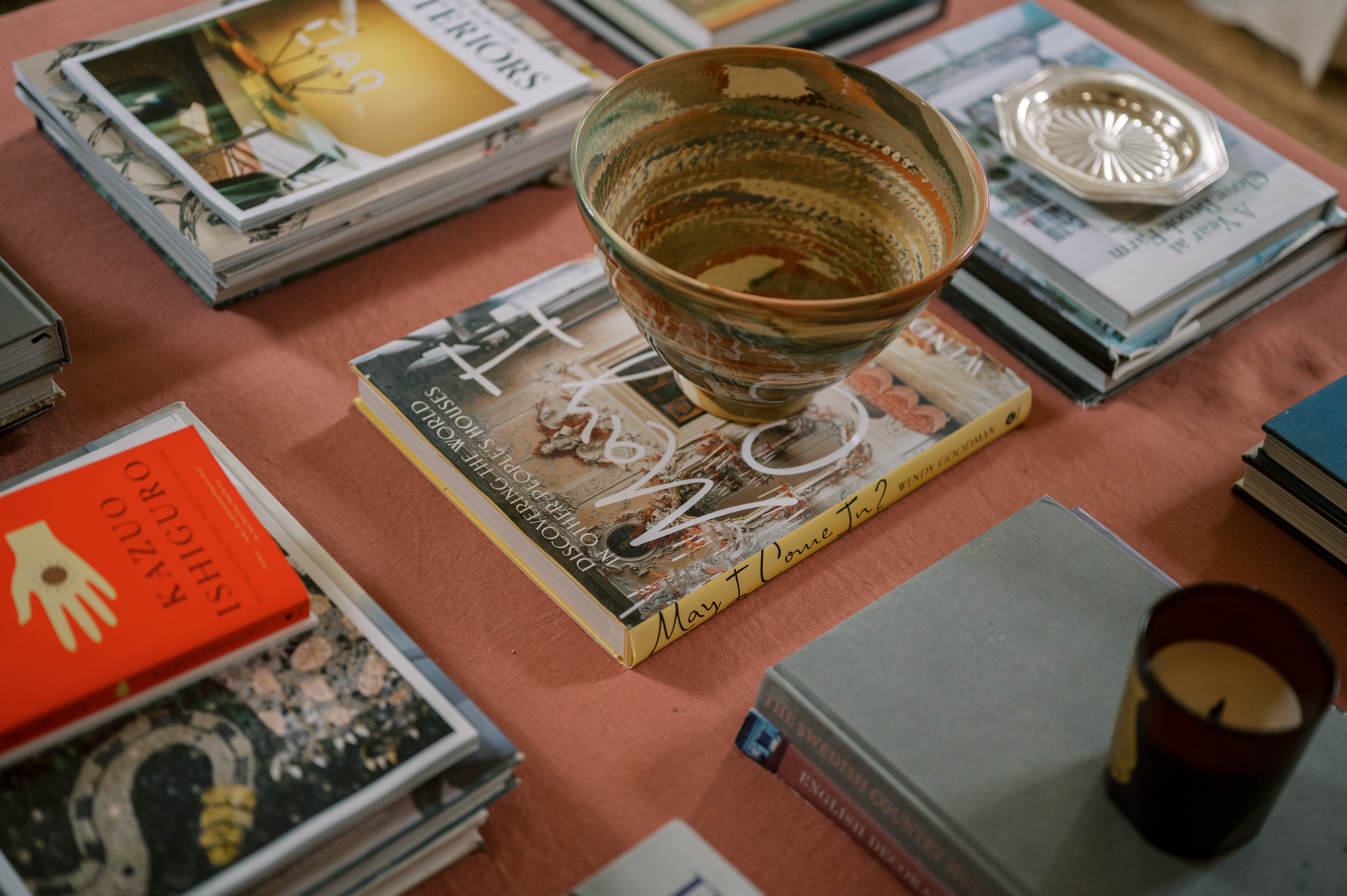 Decorative bowl on a stack of books with a warm color palette