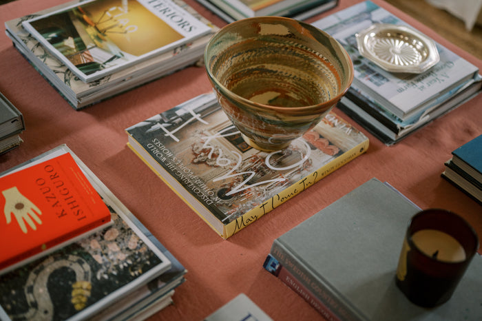 Decorative bowl on a stack of books with a warm color palette