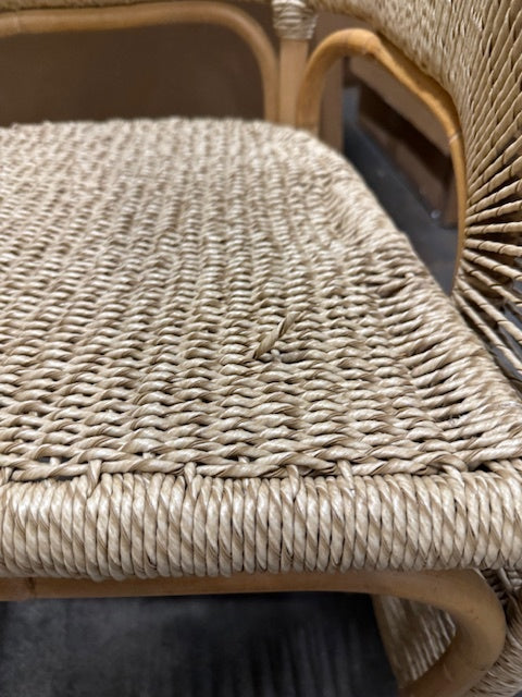 Close-up of a wicker chair seat with visible wear.- Number 4