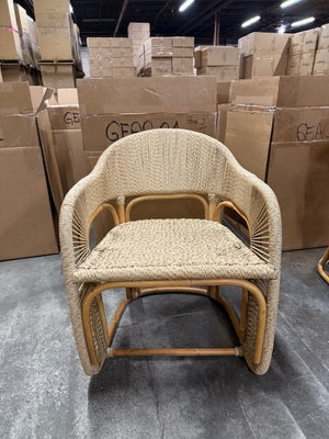 Wicker chair in a warehouse setting with stacked boxes in the background - Number 2