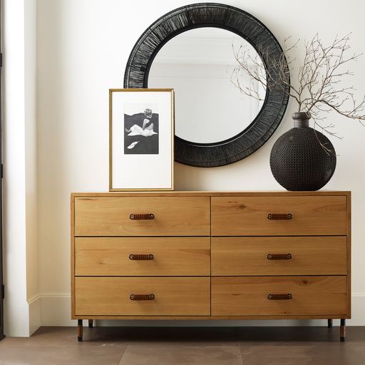 dresser with photo and plant and mirror