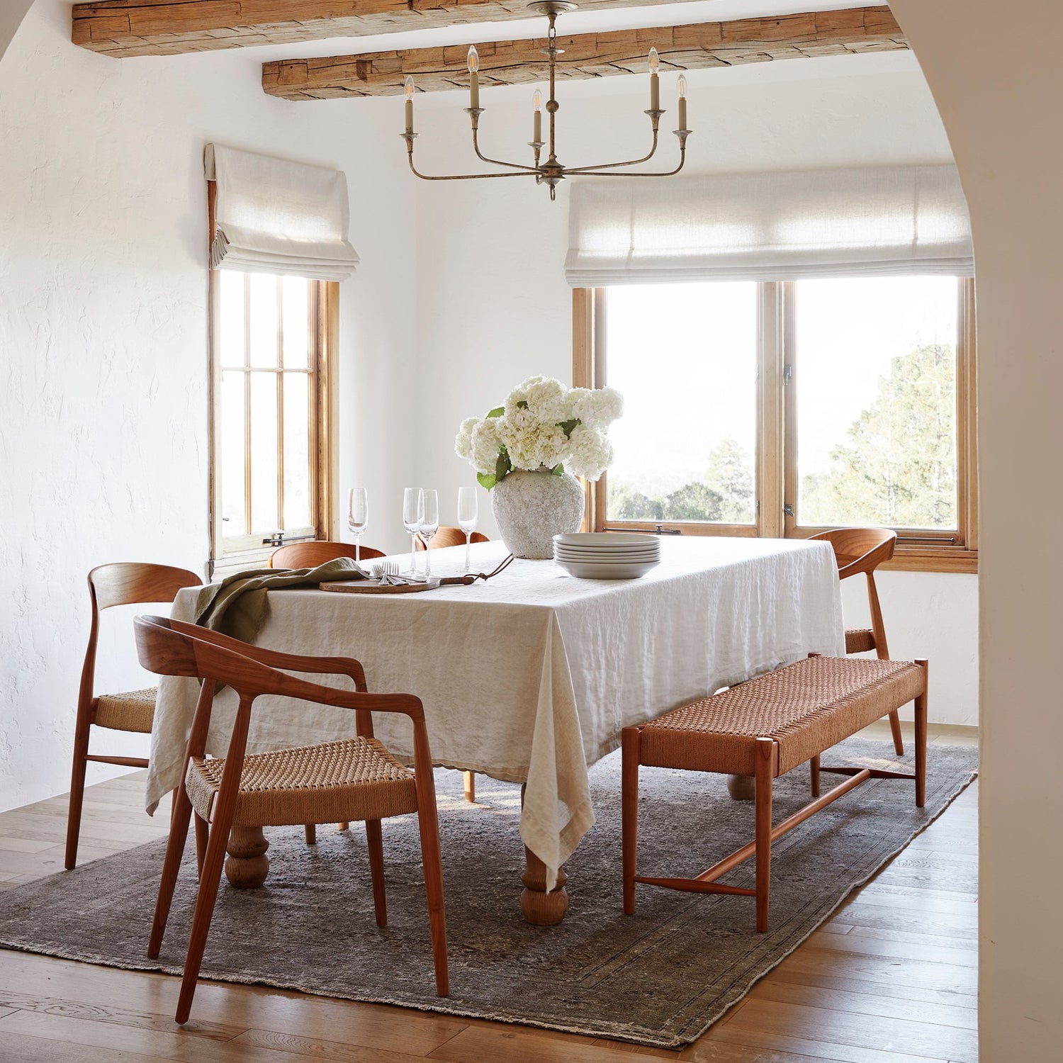ingrid woven arm chairs in oak at dining table