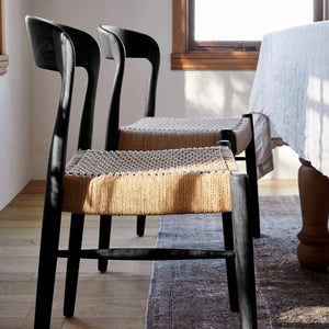 ingrid woven side chair in ebony at dining table