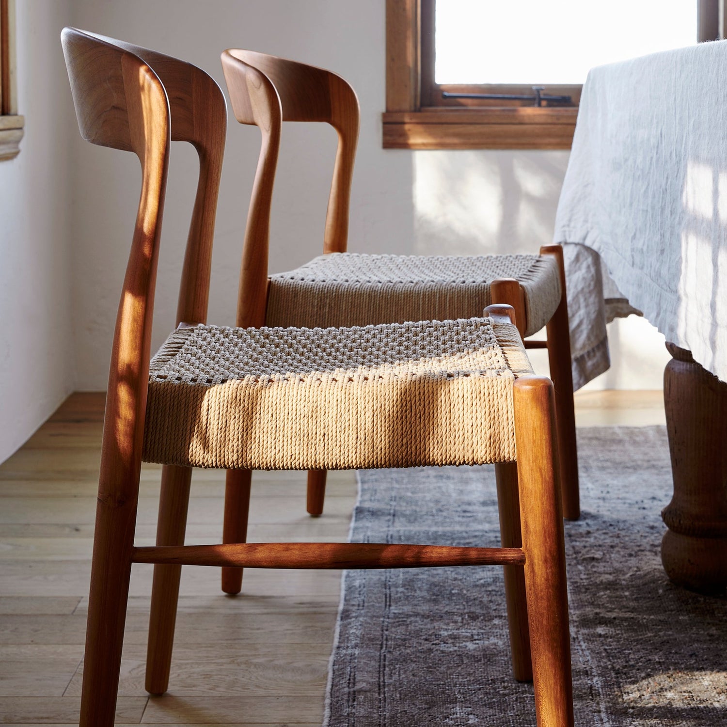 ingrid woven side chair in teak at dining table