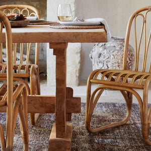 bastide rattan dining chair at table